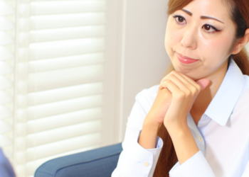 A picture of a job counselor talking to a woman, guiding her towards employment and self-sufficiency