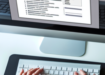 An overhead view of someone customizing their resume to fit a specific job description on their computer